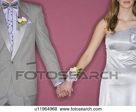 Stock Photo - Couple in prom attire holding hands. Fotosearch
