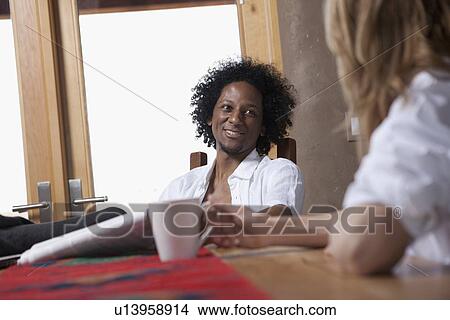 Picture - Couple relaxing over morning coffee. Fotosearch