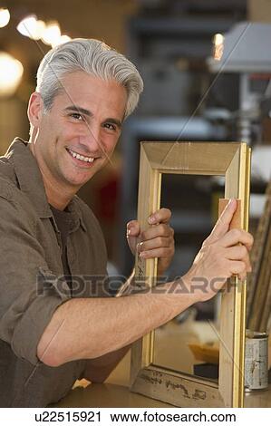 Craftsman making a picture frame View Large Photo Image Stock Image - Craftsman making a picture frame. Fotosearch