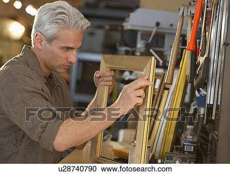 Craftsman making a picture frame View Large Photo Image Stock Image - Craftsman making a picture frame. Fotosearch