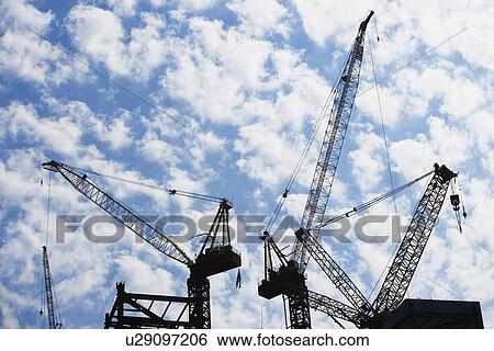 Stock Photograph - Cranes at construction site. Fotosearch