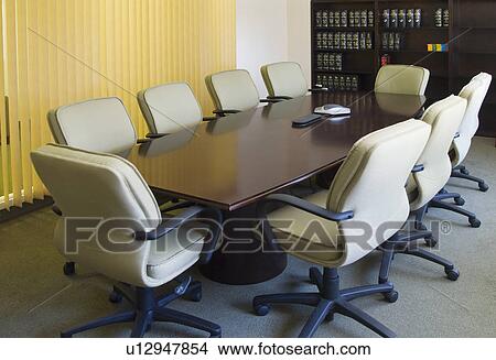 Desk and chairs in conference room View Large Photo Image Picture - Desk and chairs in conference room. Fotosearch