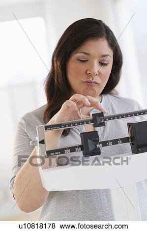 Disappointed woman standing on scale View Large Photo Image Stock Photo - Disappointed woman standing on scale. Fotosearch