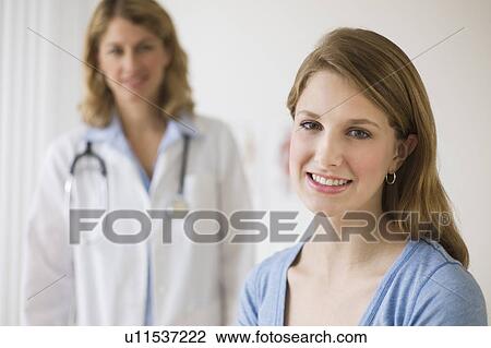 Doctor and patient in exam room View Large Photo Image Stock Image - Doctor and patient in exam room. Fotosearch