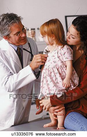 Stock Photograph - Doctor examining young child. Fotosearch