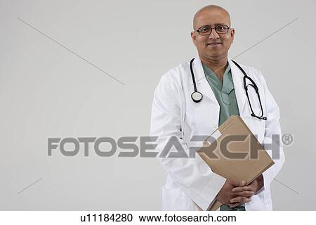 Stock Image - Doctor holding files. Fotosearch