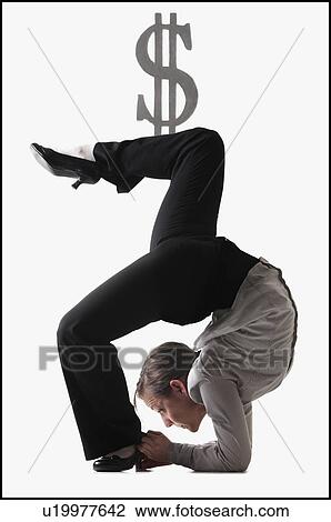 Stock Image - Dollar symbol on top of contorted businesswoman. Fotosearch