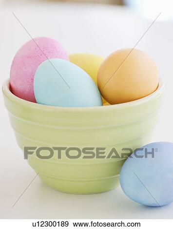 Stock Photo - Dyed Easter eggs in bowl. Fotosearch