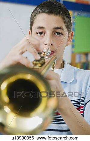 Stock Photograph - Elementary school student playing trumpet. Fotosearch