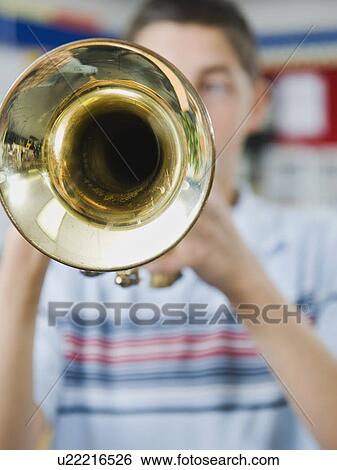 Stock Photograph - Elementary school student playing trumpet. Fotosearch