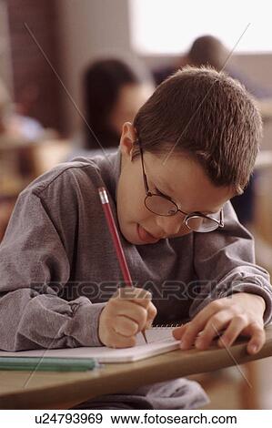 Elementary school student writing in his notebook View Large Photo Image Stock Photo - Elementary school student writing in his notebook. Fotosearch