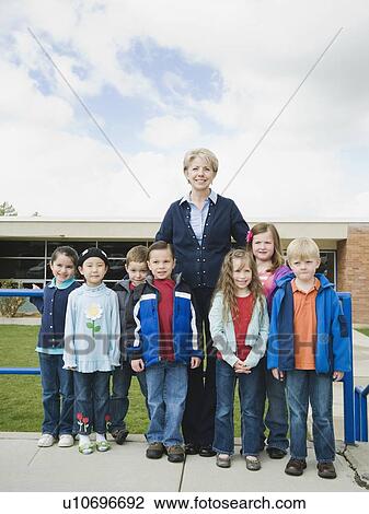 Stock Image - Elementary school students and teacher on a field trip. Fotosearch