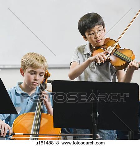 Stock Photo - Elementary school students playing instruments in music class. Fotosearch