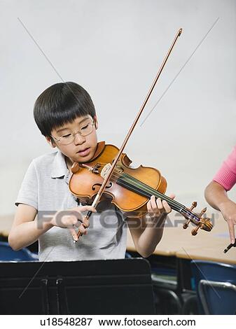 Stock Photo - Elementary school students playing instruments in music class. Fotosearch