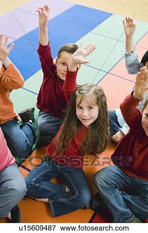 Stock Photo - Elementary school students raising their hands. Fotosearch