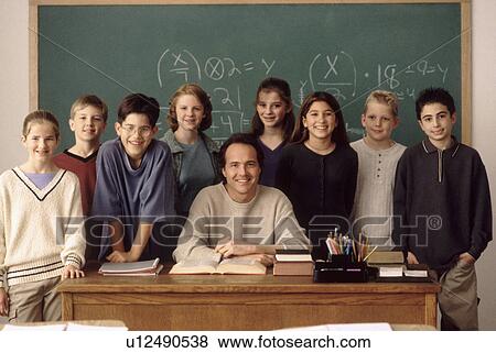 Elementary school students standing behind teacher View Large Photo Image Stock Photo - Elementary school students standing behind teacher. Fotosearch