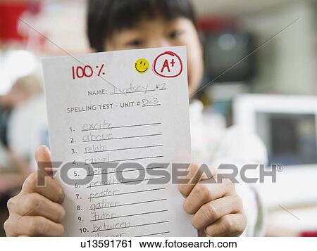 Elementary student holding an A grade paper View Large Photo Image Stock Image - Elementary student holding an A grade paper. Fotosearch