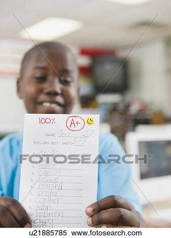 Elementary student holding an A grade paper View Large Photo Image Stock Photography - Elementary student holding an A grade paper. Fotosearch