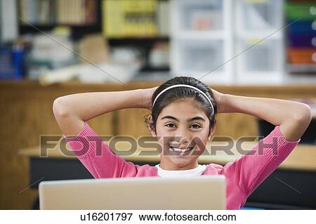 Elementary student relaxing at her desk View Large Photo Image Stock Photo - Elementary student relaxing at her desk. Fotosearch