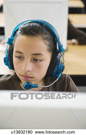 Elementary student wearing headphones in classroom View Large Photo Image Stock Image - Elementary student wearing headphones in classroom. Fotosearch