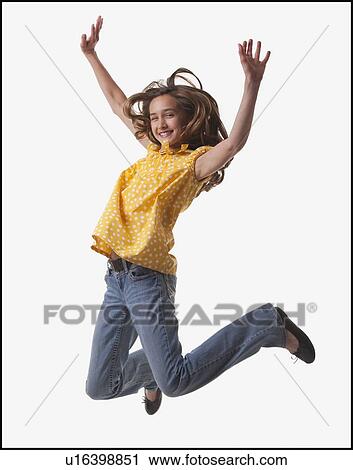 Stock Image - Excited teenage girl jumping for joy. Fotosearch