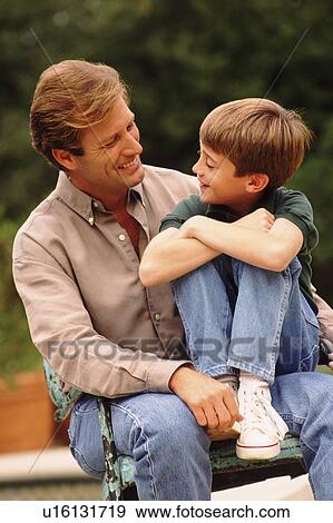 Father and son sitting outside together View Large Photo Image Stock Photo - Father and son sitting outside together. Fotosearch
