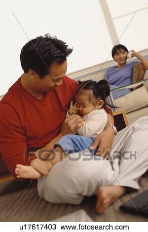 Father holding his infant daughter View Large Photo Image Stock Image - Father holding his infant daughter. Fotosearch