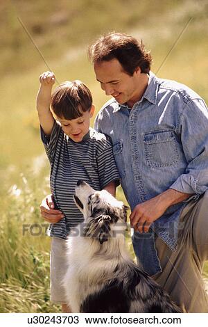 Father son and dog in field together View Large Photo Image Stock Image - Father son and dog in field together. Fotosearch