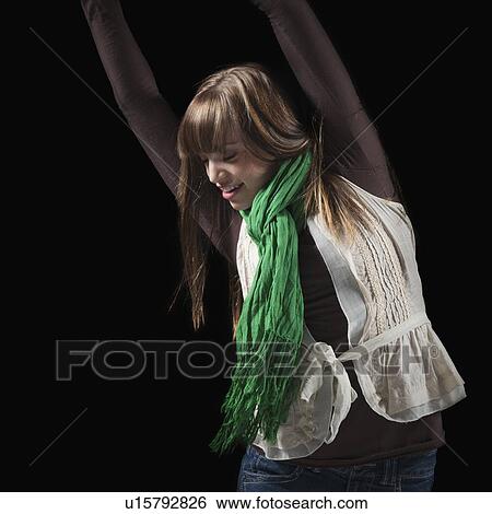 Female dancer with her arms raised above her head View Large Photo Image Stock Photograph - Female dancer with her arms raised above her head. Fotosearch