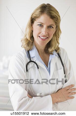 Stock Image - Female doctor in her office. Fotosearch