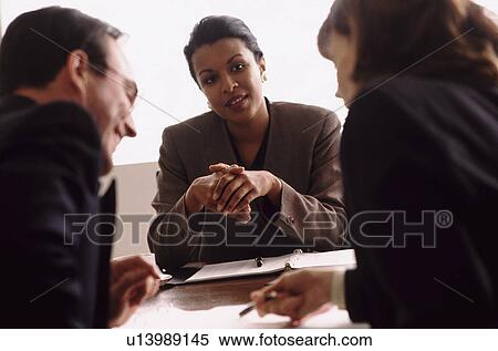 Financial advisor talking to couple View Large Photo Image Stock Photography - Financial advisor talking to couple. Fotosearch