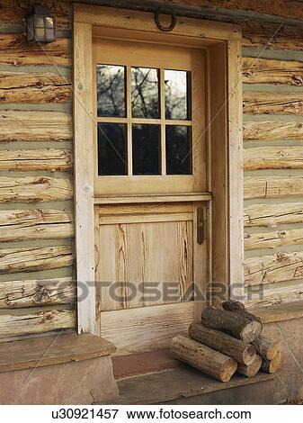 Firewood in front of door of log cabin View Large Photo Image Stock Photo - Firewood in front of door of log cabin. Fotosearch