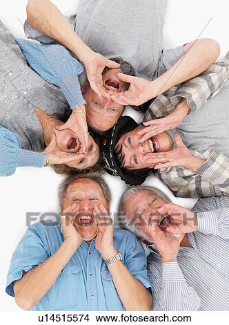 Five people lying on the floor and yelling View Large Photo Image Picture - Five people lying on the floor and yelling. Fotosearch