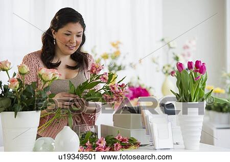 Stock Image - Florist making a floral arrangement. Fotosearch