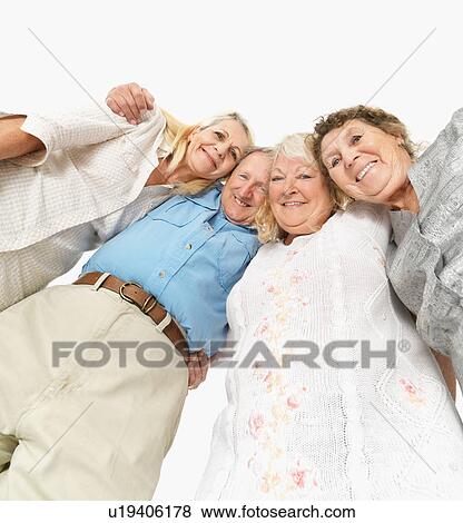 Four friends standing with their arms around each other View Large Photo Image Stock Photo - Four friends standing with their arms around each other. Fotosearch