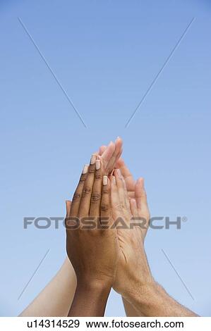 Four hands reaching up View Large Photo Image Stock Photo - Four hands reaching up. Fotosearch