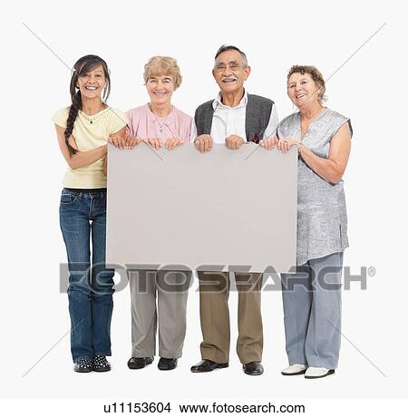 Picture - Four people holding a blank poster. Fotosearch
