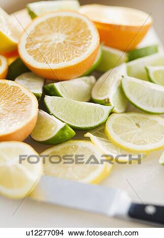 Freshly cut lemons limes and oranges View Large Photo Image Picture - Freshly cut lemons limes and oranges. Fotosearch