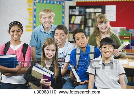 Stock Image - Group of elementary school students in classroom. Fotosearch