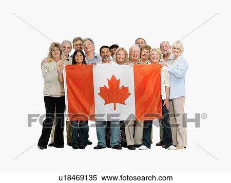 Stock Photography - Group of people holding a Canadian flag. Fotosearch