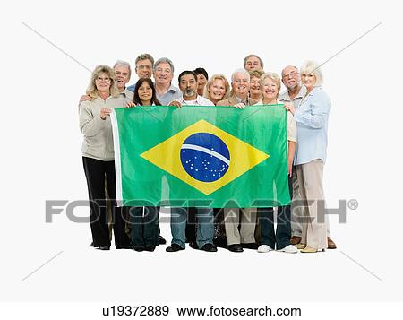Group of people holding the Brazilian flag View Large Photo Image Stock Photo - Group of people holding the Brazilian flag. Fotosearch
