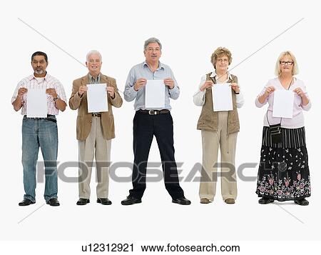 Stock Image - Group of people standing in a row holding papers. Fotosearch