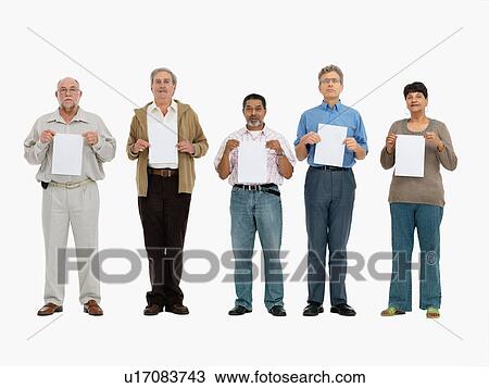 Group of people standing in a row holding papers View Large Photo Image Stock Image - Group of people standing in a row holding papers. Fotosearch