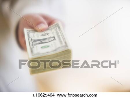 Picture - Hand holding stack of money. Fotosearch