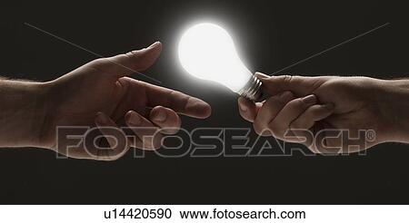 Hand passing a light bulb to another hand View Large Photo Image Stock Image - Hand passing a light bulb to another hand. Fotosearch