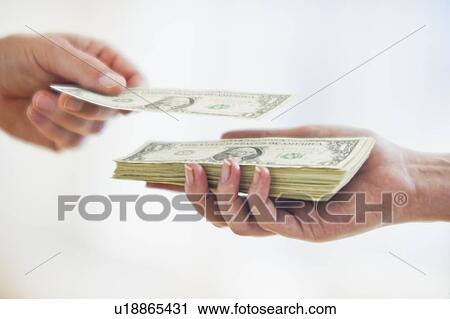 Hand putting dollar bill on top of stack of money View Large Photo Image Stock Image - Hand putting dollar bill on top of stack of money. Fotosearch