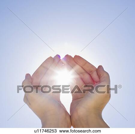 Stock Image - Hands framing sunshine. Fotosearch