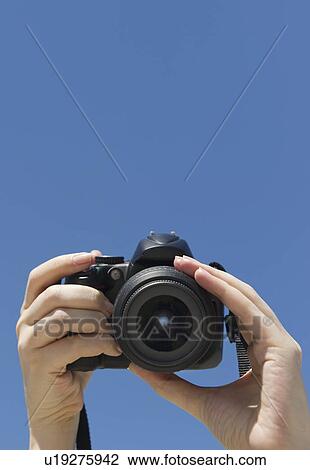 Stock Image - Hands holding a digital camera. Fotosearch