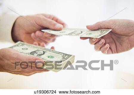 Picture - Hands passing dollar bill. Fotosearch