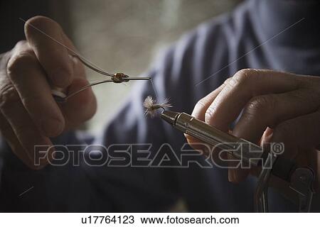 Hands working on fly fishing hook View Large Photo Image Stock Image - Hands working on fly fishing hook. Fotosearch